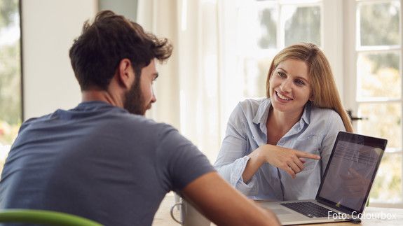 Couple With Laptop Sitting At Table Working From Home Together couple, at home, laptop, computer, online, working from home, connected, the internet, tech, shopping, buying, choosing, holiday, finance, personal finance, checking, investments, savings, pension, retirement, man, men, male, woman, women, female, two people, people, person, together, caucasian, 20s, twenties, 30s, thirties, horizontal, front view, waist up, happy, smiling, laughing, sitting, table